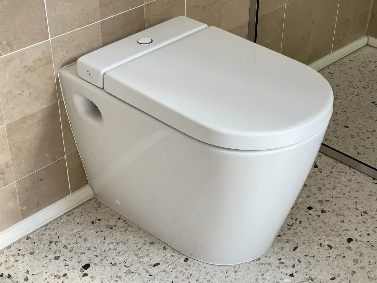 New modern white toilet installed in a Bali villa bathroom